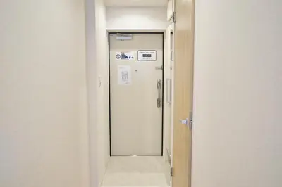 an empty corridor with a door in a room at monthly akebonobashi in Tokyo