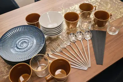 a table with plates and spoons and glasses on it at monthly akebonobashi in Tokyo