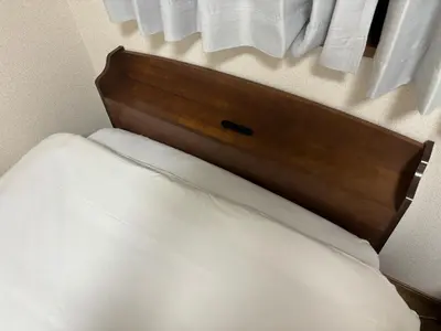 a close up of a bed with a wooden headboard at S,F, Heights - Vacation STAY 19865 in Tokyo
