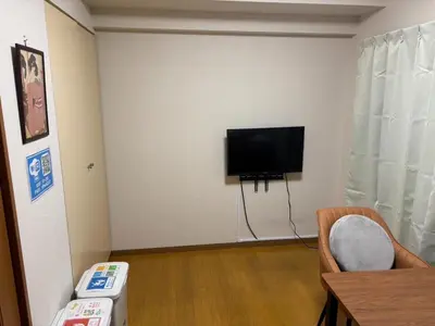 a living room with a flat screen tv on a wall at S,F, Heights - Vacation STAY 19865 in Tokyo