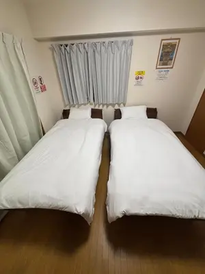 two beds sitting next to each other in a room at S,F, Heights - Vacation STAY 19865 in Tokyo