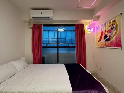 a bedroom with a bed with red curtains and a window at 2nd Narumitsu Building, Room 302 - Vacation STAY 24150v in Tokyo