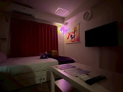 a room with two beds and a table and a tv at 2nd Narumitsu Building, Room 302 - Vacation STAY 24150v in Tokyo