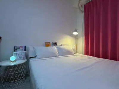 a bedroom with a white bed and a red curtain at 2nd Narumitsu Building, Room 302 - Vacation STAY 24150v in Tokyo