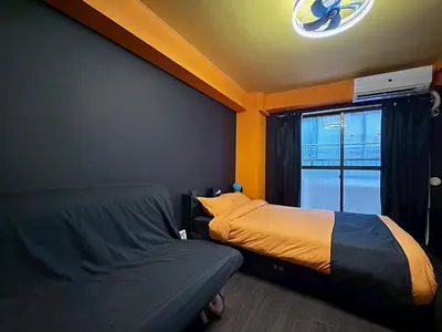 a bedroom with two beds and a window at Dai2 Narumitsu Building 301 - Vacation STAY 29234v in Tokyo