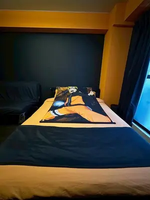 a bedroom with a bed with a blue head board at Dai2 Narumitsu Building 301 - Vacation STAY 29234v in Tokyo