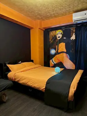 a bedroom with a bed with a painting of a football player at Dai2 Narumitsu Building 301 - Vacation STAY 29234v in Tokyo