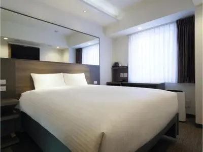 a bedroom with a large bed and a large mirror at Far East Village Hotel Tokyo Asakusa - Vacation STAY 46814v in Tokyo