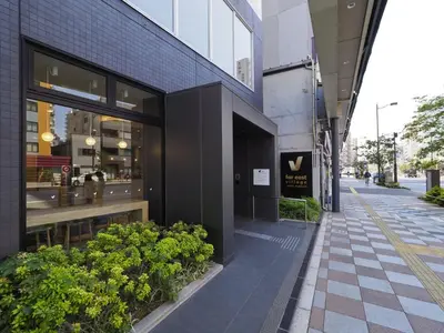 a building on a street with plants in front of it at Far East Village Hotel Tokyo Asakusa - Vacation STAY 46814v in Tokyo