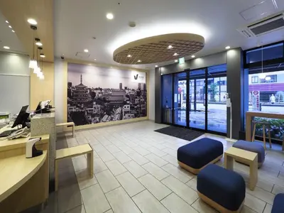 an office with a desk and blue chairs in a room at Far East Village Hotel Tokyo Asakusa - Vacation STAY 46944v in Tokyo