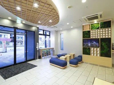 a waiting room with blue stools in a building at Far East Village Hotel Tokyo Asakusa - Vacation STAY 46944v in Tokyo