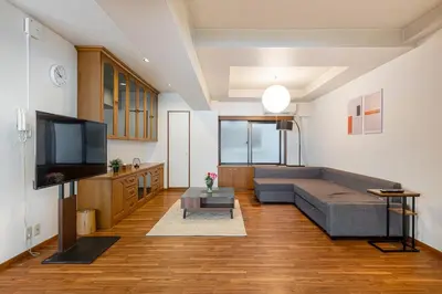 a living room with a couch and a flat screen tv at \u671f\u9593\u9650\u5b9a \u6d45\u8349\u6a4b3floor in Tokyo