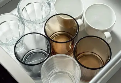 a drawer filled with different types of glasses and cups at \u671f\u9593\u9650\u5b9a \u6d45\u8349\u6a4b3floor in Tokyo