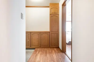 an empty room with a wooden door and wooden floors at \u671f\u9593\u9650\u5b9a \u6d45\u8349\u6a4b3floor in Tokyo