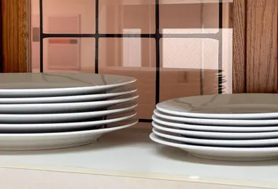 a stack of plates sitting on a counter next to other plates at \u671f\u9593\u9650\u5b9a \u6d45\u8349\u6a4b3floor in Tokyo
