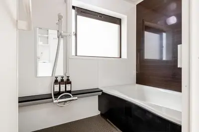 a white bathroom with a sink and a window at \u671f\u9593\u9650\u5b9a \u6d45\u8349\u6a4b4floor in Tokyo