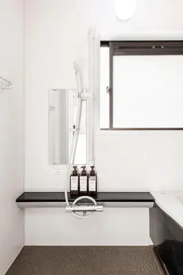 a white bathroom with a shower and a mirror at \u671f\u9593\u9650\u5b9a \u6d45\u8349\u6a4b4floor in Tokyo