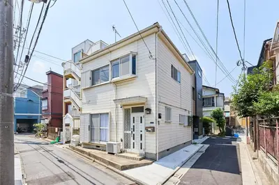 a white house on the side of a street at Yik\u7acb\u82b12\u4e01\u76ee in Tokyo