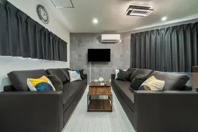 a living room with two couches and a tv at \u5225\u90b8Zen\u5c0f\u5ca9 Bettei Zen Koiwa in Tokyo
