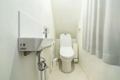 a white bathroom with a toilet and a sink at \u5225\u90b8Zen\u5c0f\u5ca9 Bettei Zen Koiwa in Tokyo