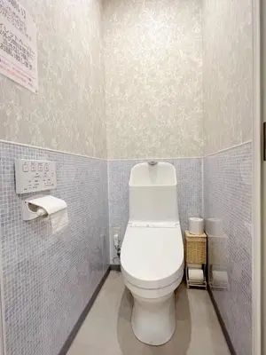a white toilet in a bathroom with blue tiles at aMIYAVI 2F in Tokyo