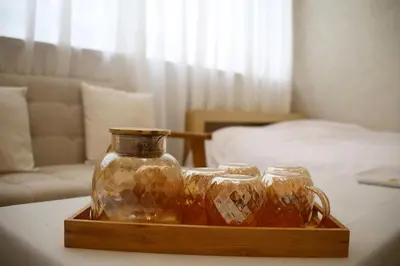 a glass jar on a wooden tray on a table at aMIYAVI 2F in Tokyo