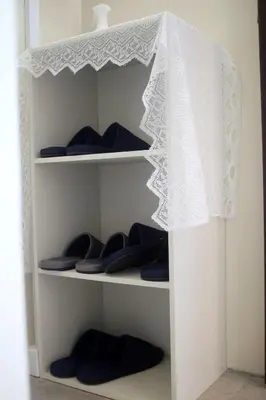 a closet with blue shoes and a white curtain at aMIYAVI 2F in Tokyo