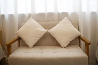 two pillows sitting on a couch in front of a window at aMIYAVI 2F in Tokyo