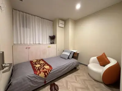 a bedroom with a bed and a chair at aMIYAVI 2F in Tokyo