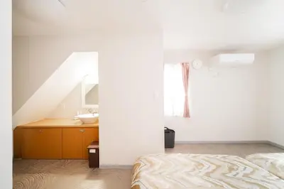 a bathroom with a sink and a bed in a room at Spacious 3-Story House with 2 Baths, 7 min to Metro direct to Akihabara Ueno Ginza in Tokyo