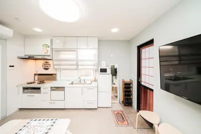 a kitchen with white cabinets and a sink at Spacious 3-Story House with 2 Baths, 7 min to Metro direct to Akihabara Ueno Ginza in Tokyo