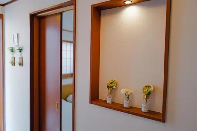 a bathroom mirror with three vases with flowers on it at Akira Hiro House - Room202 in Tokyo