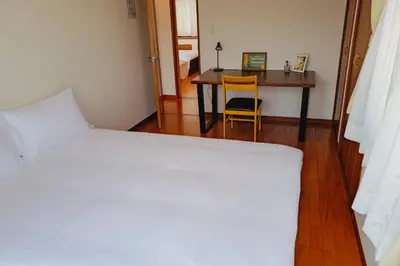 a bedroom with a bed and a desk and a table at Akira Hiro House - Room202 in Tokyo