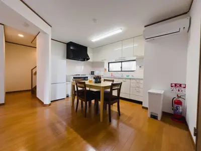 a kitchen with a table and chairs in a room at Akira Hiro House - Room202 in Tokyo