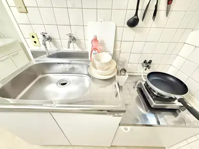 a kitchen counter with a sink and a frying pan at Shinjuku Waseda B2 in Tokyo