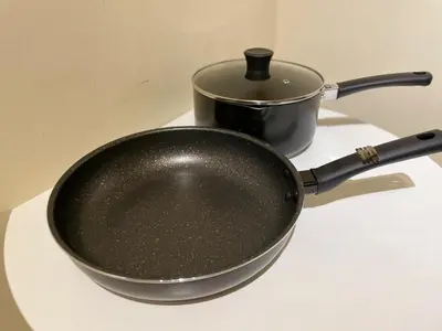 a black pan sitting on a stove with a pot at SORA Shibuya in Tokyo