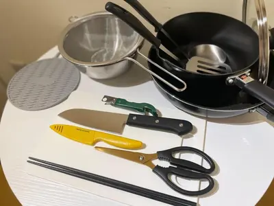 a table with scissors and a pan and a whisk at SORA Shibuya in Tokyo