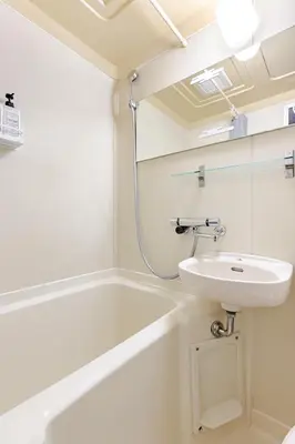 a bathroom with a sink and a bath tub at SORA Shibuya in Tokyo