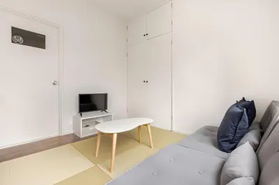 a living room with a couch and a table at SORA Shibuya in Tokyo
