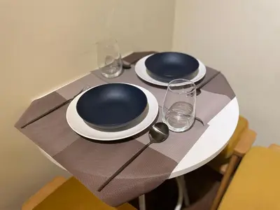 a table with two plates and glasses on it at SORA Shibuya in Tokyo