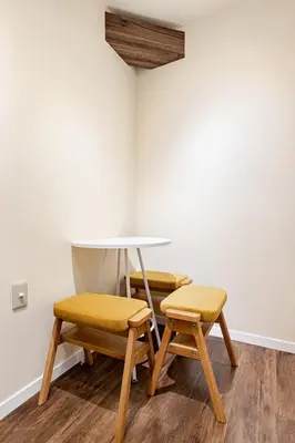 three chairs and a table in a room at SORA Shibuya in Tokyo