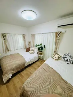 a bedroom with two beds and a window at 5-minute walk from Otsuka Station on the Yamanote Line, 20 square meters On the 3rd floor No elevator in Tokyo