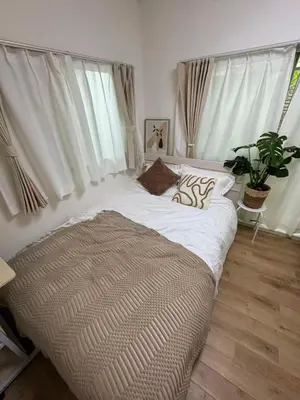 a large bed in a room with windows at 5-minute walk from Otsuka Station on the Yamanote Line, 20 square meters On the 3rd floor No elevator in Tokyo