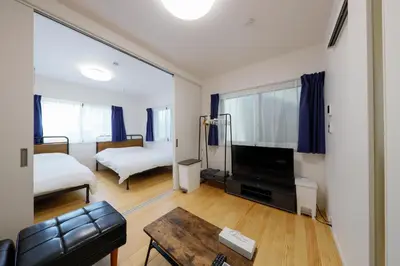 a living room with a couch and a bed and a tv at Convertel Setagaya - Vacation STAY 45953v in Tokyo