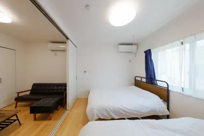 a small room with two beds and a couch at Convertel Setagaya - Vacation STAY 45953v in Tokyo