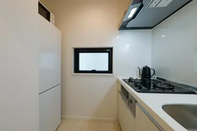 a small kitchen with a sink and a stove at Convertel Setagaya - Vacation STAY 45953v in Tokyo