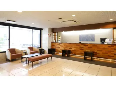 a lobby with a waiting room with chairs and a table at Smile Hotel Tokyo Ayase Ekimae - Vacation STAY 62840v in Tokyo