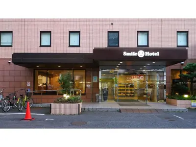 a store front of a building with a bike parked outside at Smile Hotel Tokyo Ayase Ekimae - Vacation STAY 62840v in Tokyo
