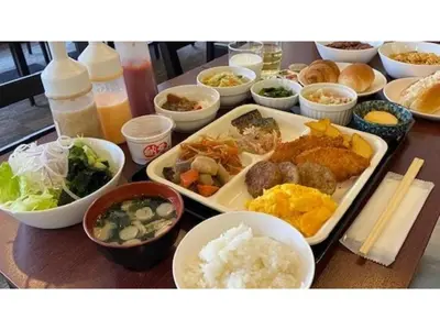 a table with plates of food and bowls of food at Smile Hotel Tokyo Ayase Ekimae - Vacation STAY 62844v in Tokyo