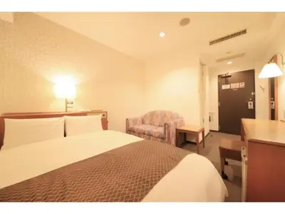 a hotel room with a bed and a chair at Smile Hotel Tokyo Ayase Ekimae - Vacation STAY 62850v in Tokyo